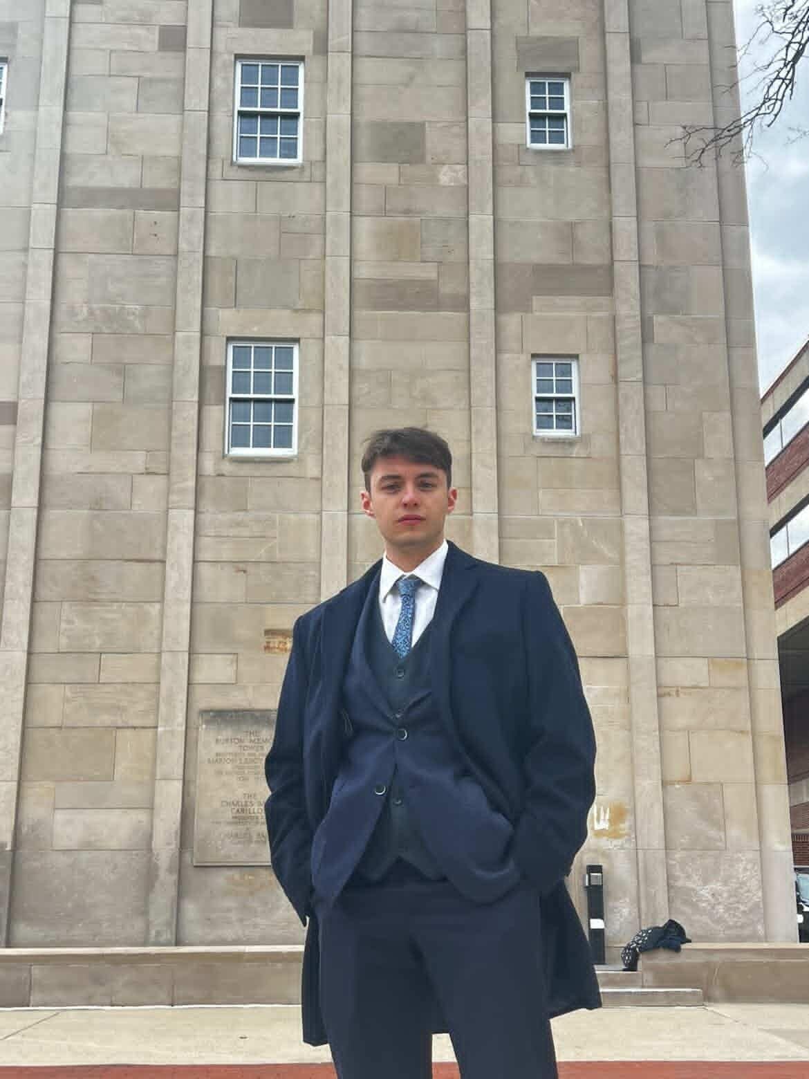 Callum Holley standing in front of the Burton Memorial Tower at the University of Michigan