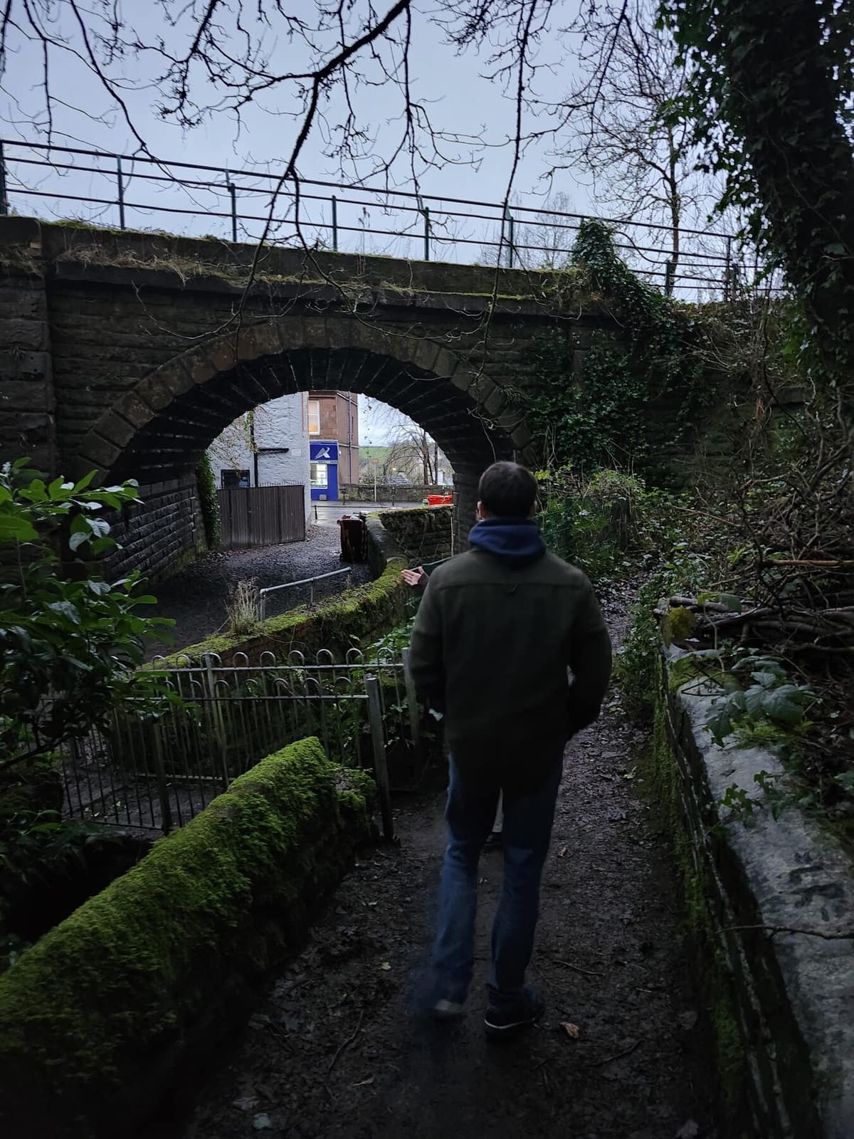 Walking under a stone bridge, Scotland